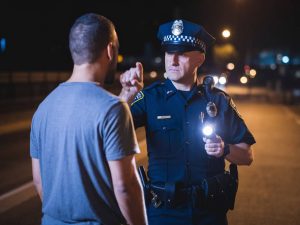 POLICE OFFICER INVESTIGATING DRUNK DRIVING AND ADMINISTERING THE DUI EYE TEST KNOWN AS THE HGN